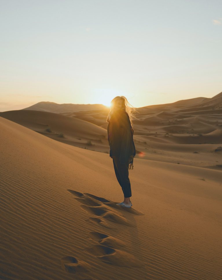 The same desert photo with a color grade saved as a LUT: cool teal shadows and haze over rich amber sand