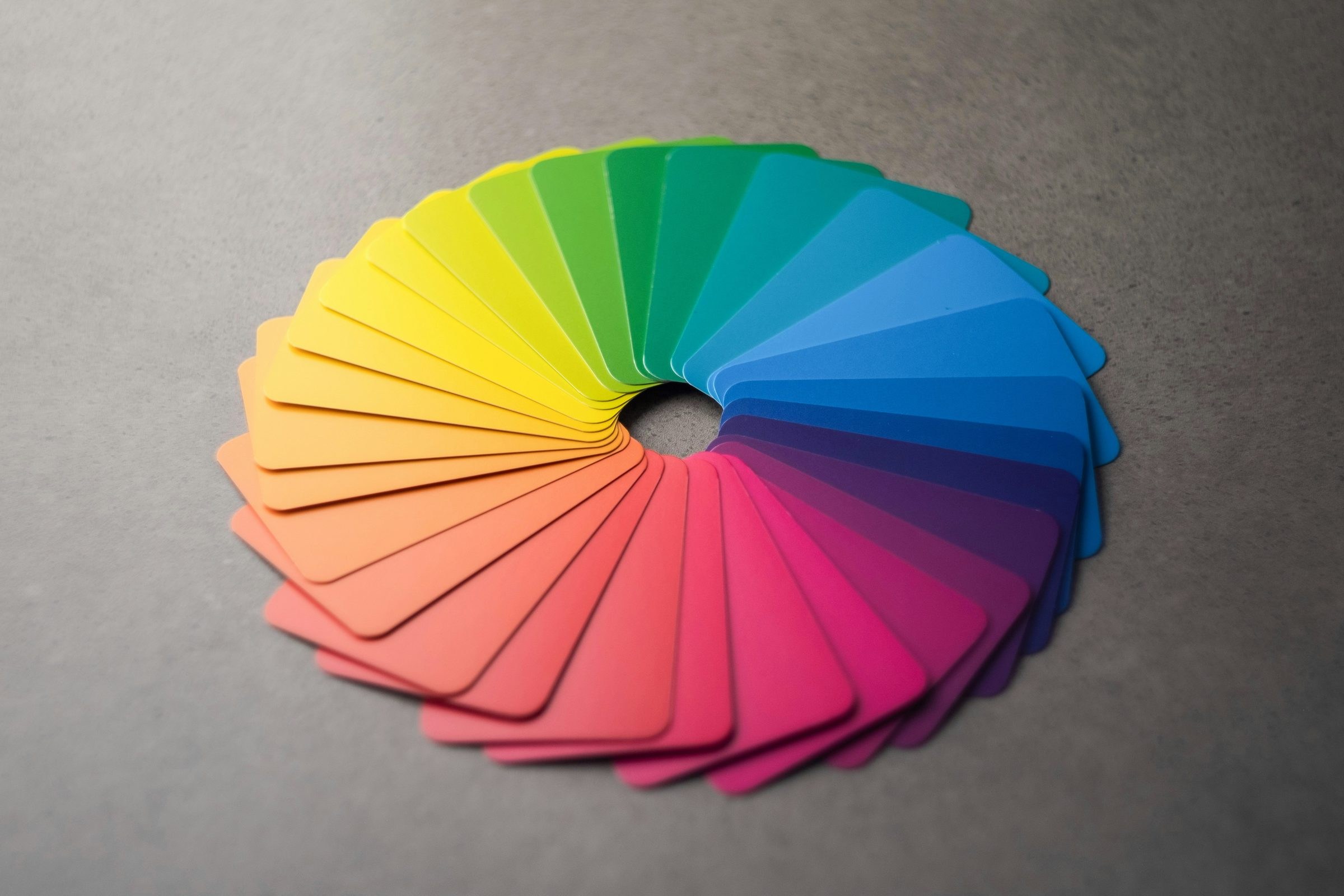 Color theory in photography: a fan of paper color swatches laid out as a color wheel