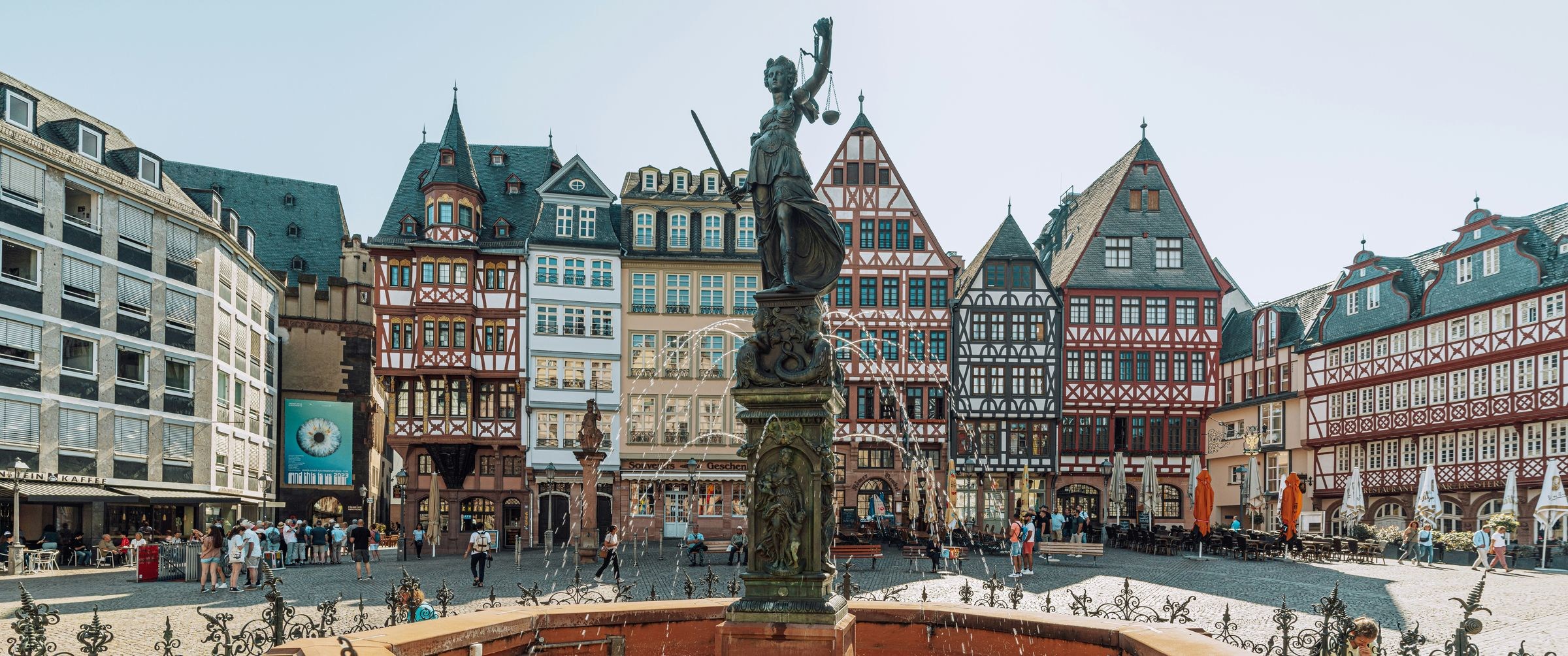The Römerberg square in Frankfurt photographed at 18mm, with the Justitia fountain in the middle and timber-framed houses behind