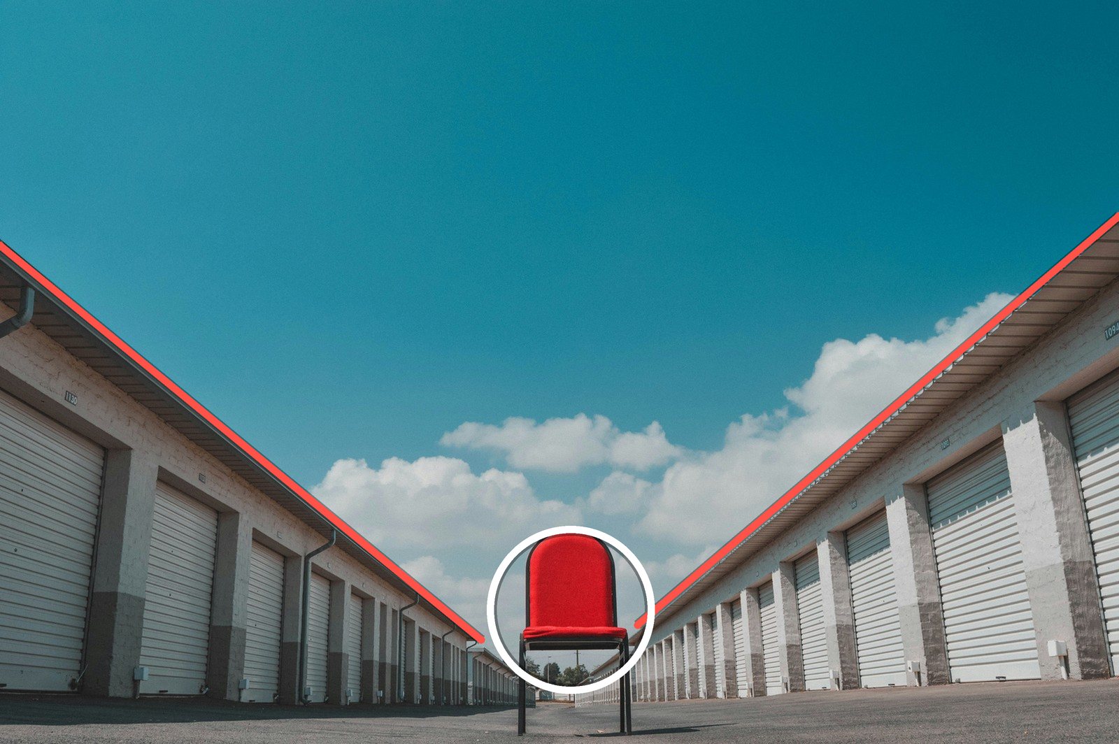 Leading lines in photography example: two rows of storage units converge on a red chair in the middle of the frame