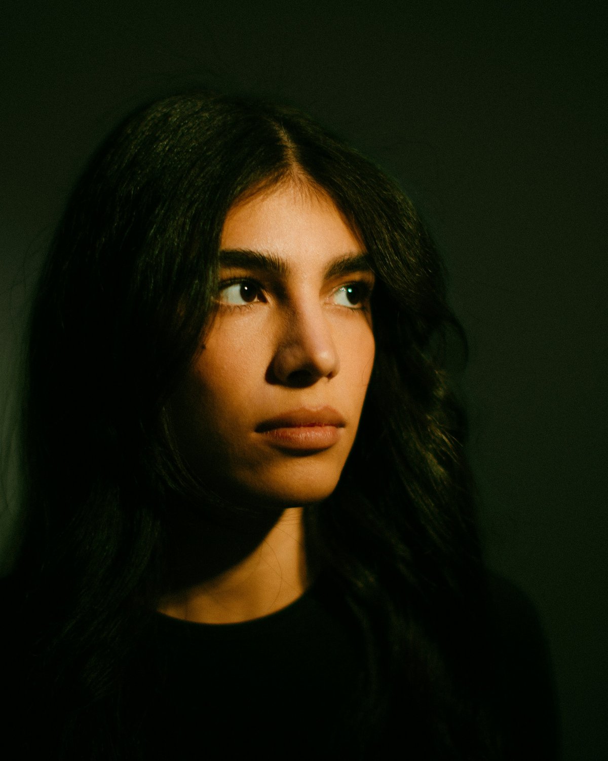 Portrait lit with loop lighting, with a small nose shadow falling to one side