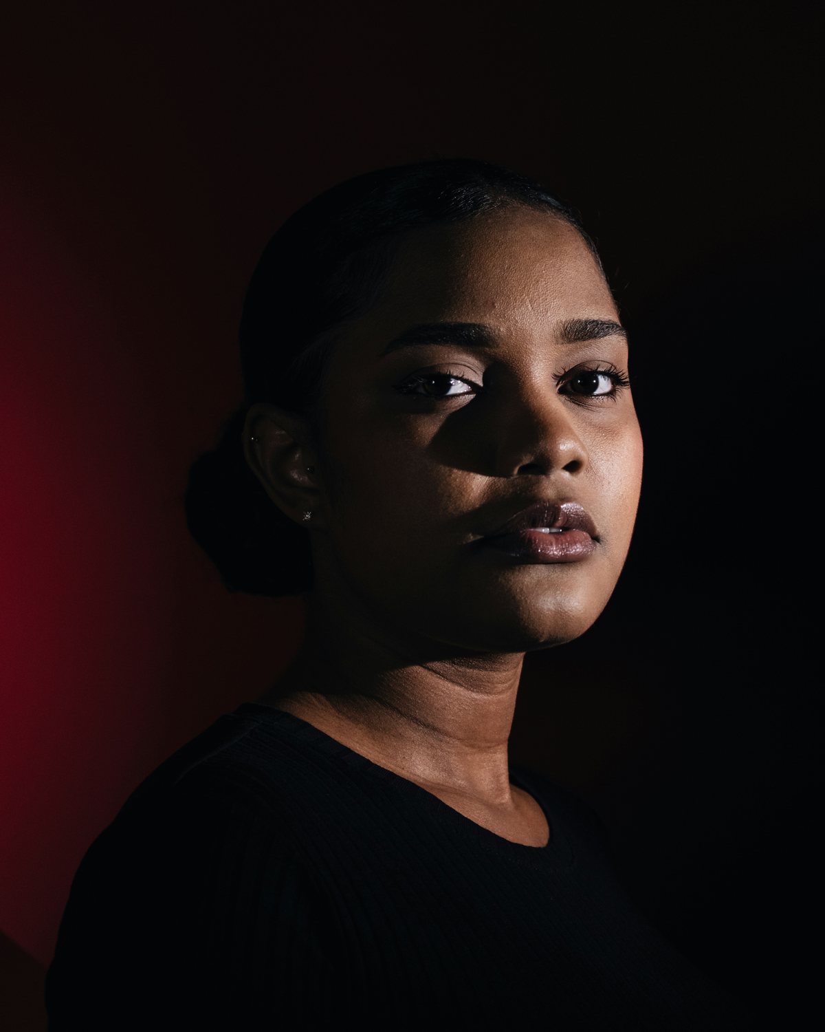 Portrait lit with Rembrandt lighting, with a triangle of light on the shadow-side cheek