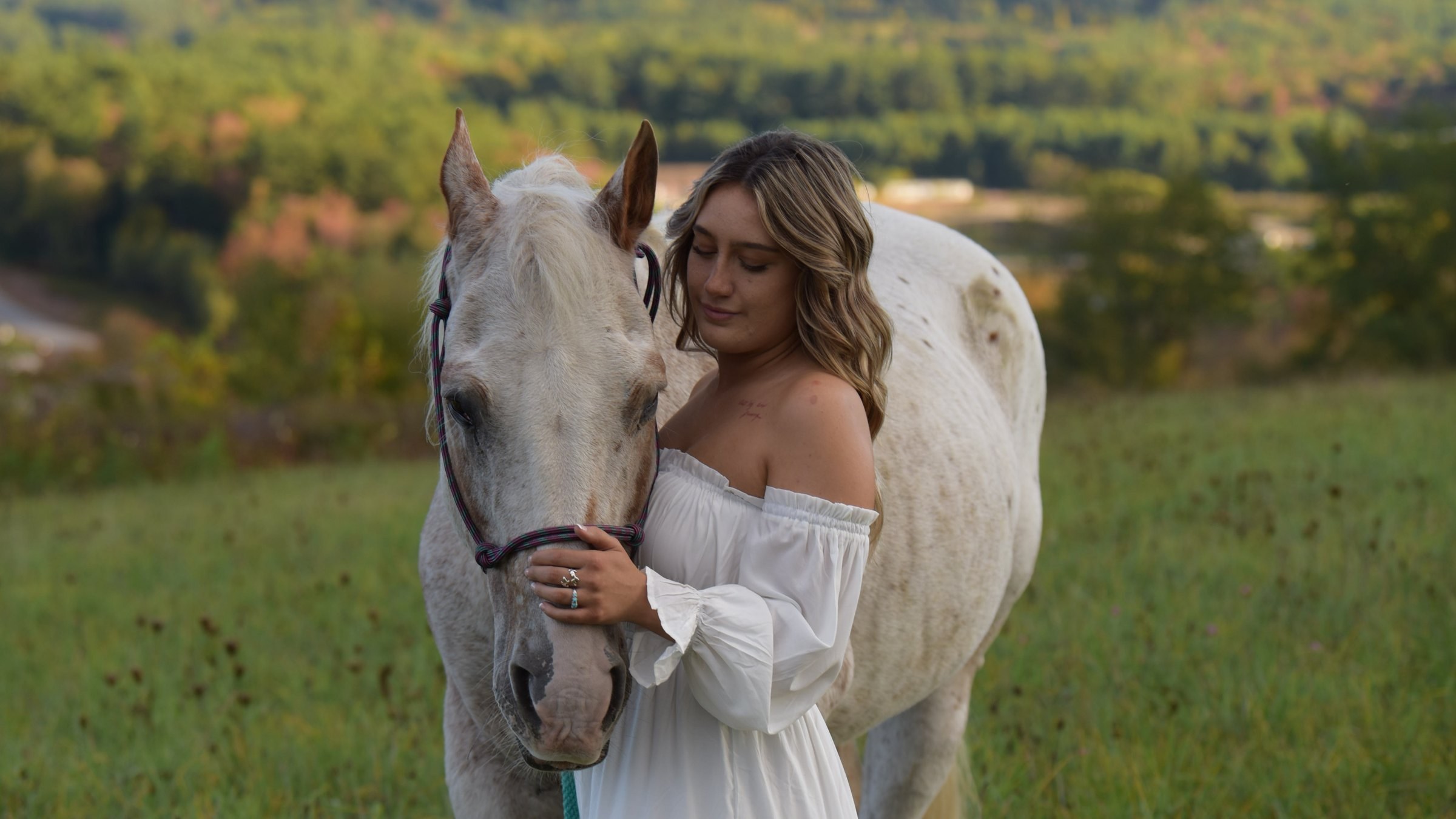 RAW vs JPEG vs HEIF: a woman in a white dress standing with a white horse in a field at golden hour, the sample photo from 30 Days of Lightroom Day 13